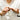 Model in white dress shirt pumping calm serum by osmosis into her hand before applying
