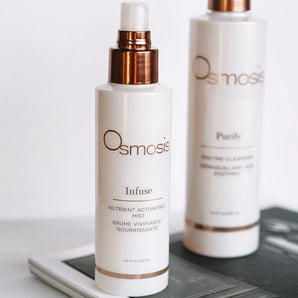 two bottles of osmosis beauty products displayed on countertop