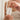 Model with pretty hands is holding a bottle with a pump of rescue serum