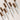 eight curling and defining mascara lined up in a row with one open on white background