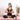 model doing a yoga pose sitting on yoga mat with a bottle of immune defense elixir by osmosis