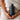 model holding a bottle of recovery by osmosis while she is wrapped in a towel