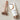 tube of rejuvenating body cream and roller tool displayed on marble countertop
