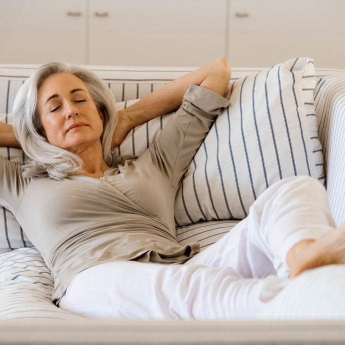 older female sunlighten model relaxing on the couch comfortably