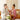 male and female models sitting on their leather couch in robes applying revealu skincare products