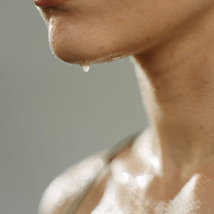 Close up of female model with sweat dripping off of her chin 