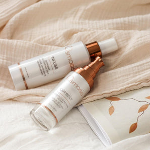 two bottles of osmosis beauty products displayed on beige linens