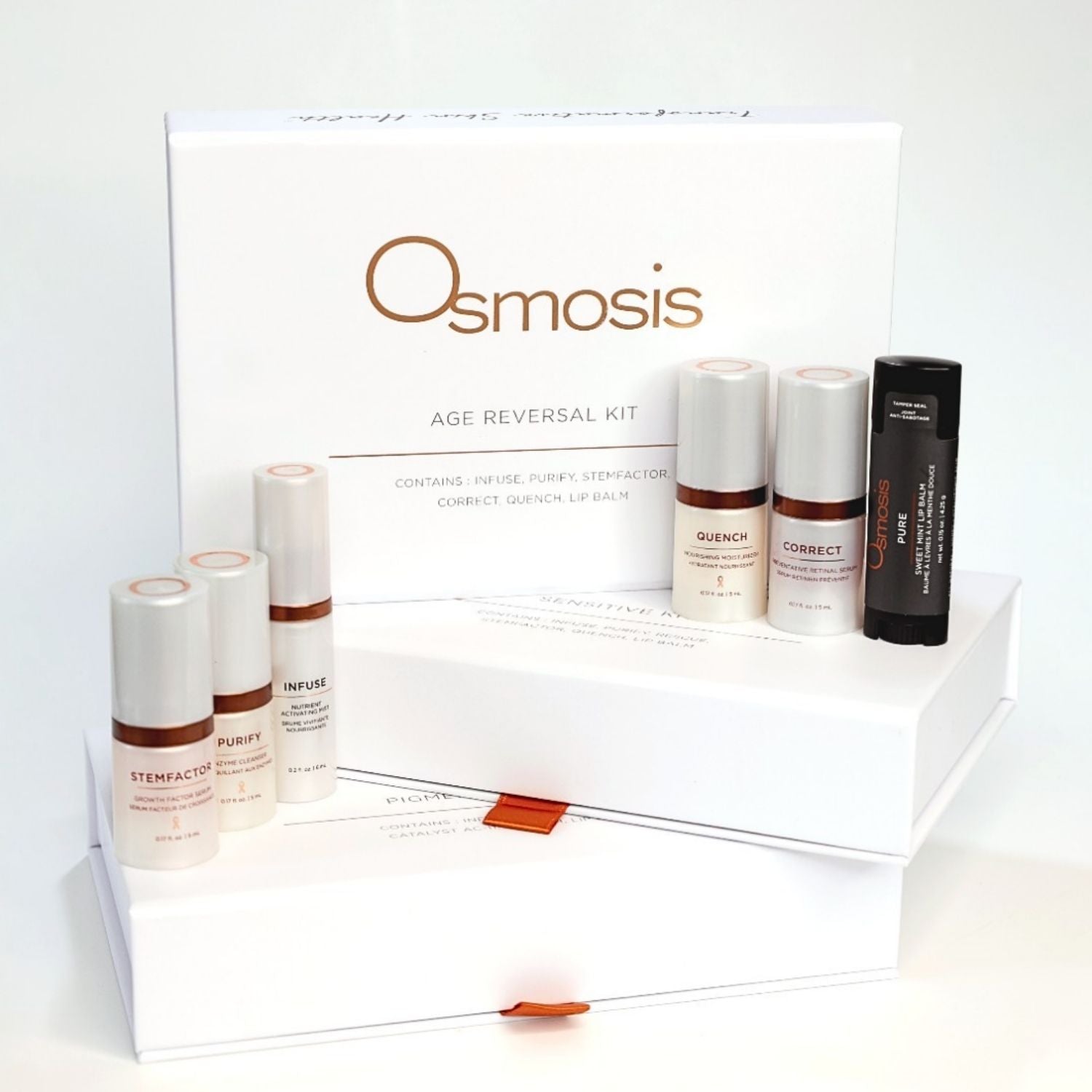 Pearl and bronze colored osmosis skincare bottles displayed in front of white box on a white background