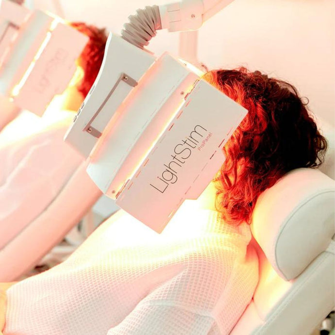 female client laying on treatment bed is receiving a lightstim pro panel facial at MK Skin Studio