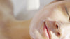 esthetician painting facial beauty products by osmosis onto to a clients face
